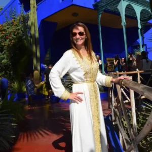 Woman posing in front of the blue house at Jardin Majorelle, Marrakech, Morocco. Visit Morocco Tours