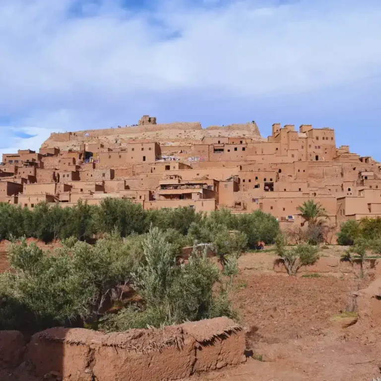 Aït Benhaddou Kasbah in Ouarzazate under blue sky, Top 10 Places to Visit in Morocco. Visit Morocco Tours