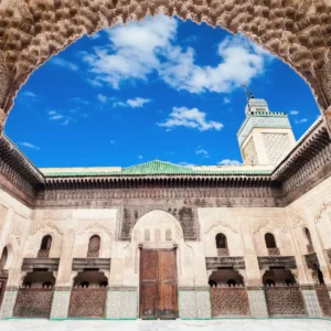 Free things to do in Fez | Bou Inania Madrasa with intricate tilework, carved wood, and open courtyard. Visit Morocco Tours