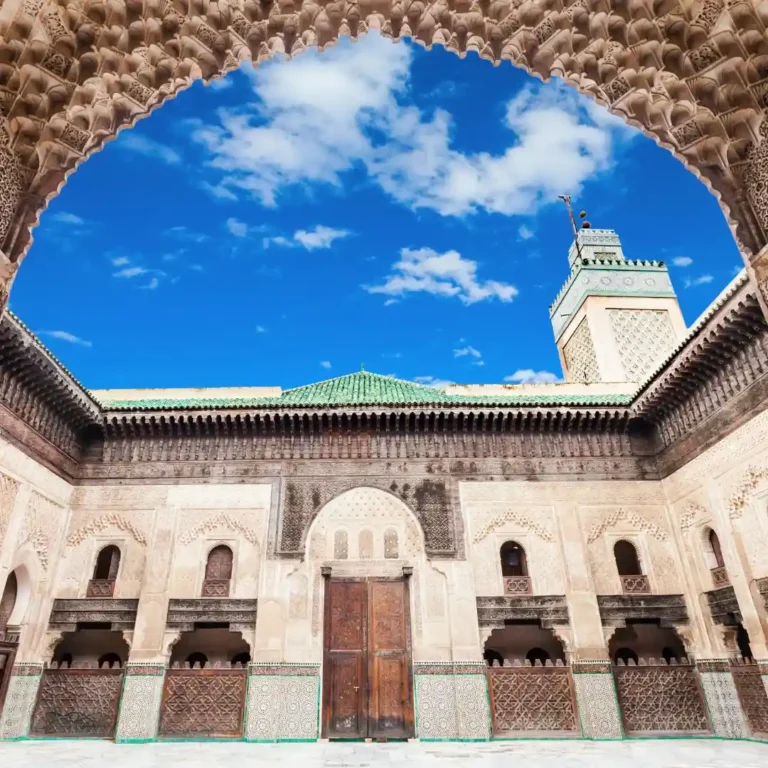 Free things to do in Fez | Bou Inania Madrasa with intricate tilework, carved wood, and open courtyard. Visit Morocco Tours