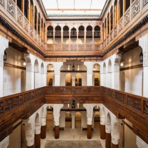 Free things to do in Fez | Nejjarine Museum interior with carved wood, arches, and central courtyard seen from above. Visit Morocco Tours