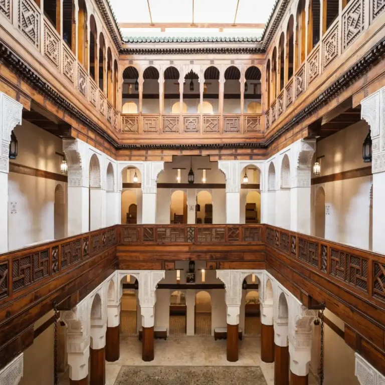 Free things to do in Fez | Nejjarine Museum interior with carved wood, arches, and central courtyard seen from above. Visit Morocco Tours