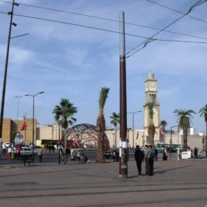 Free things to do in Casablanca | United Nations Square with iconic red metal sculpture and historic buildings. Visit Morocco Tours