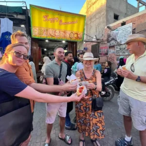 Food Tour Marrakech guests sampling fresh spices at the market. Visit Morocco Tours