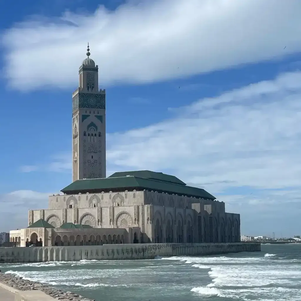 The majestic Hassan II Mosque in Casablanca at sunset, overlooking the Atlantic Ocean. Visit Morocco Tours