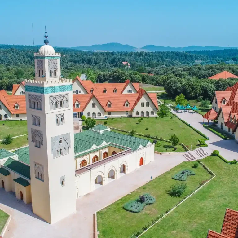 Mohamed VI Mosque in Ifrane, Morocco, showcasing traditional Moroccan architecture in alpine surroundings. Visit Morocco Tours