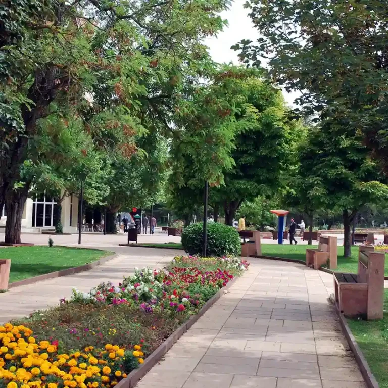 Scenic garden and park in Ifrane, Morocco, with greenery and walking paths. Visit Morocco Tours