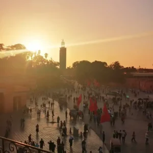 Jemaa el-Fnaa square at golden hour with Koutoubia Mosque in background Marrakech. Visit Morocco Tours