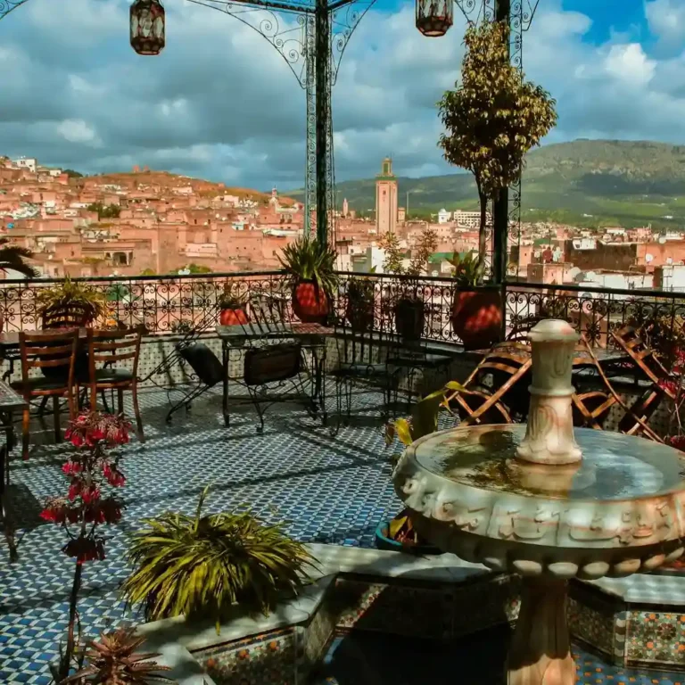 Panoramic view of Marrakech medina showing red-earth buildings and skyline. Visit Morocco Tours
