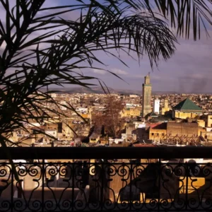 Aerial view of the ancient Fez medina showing rooftops and traditional architecture. Visit Morocco Tours
