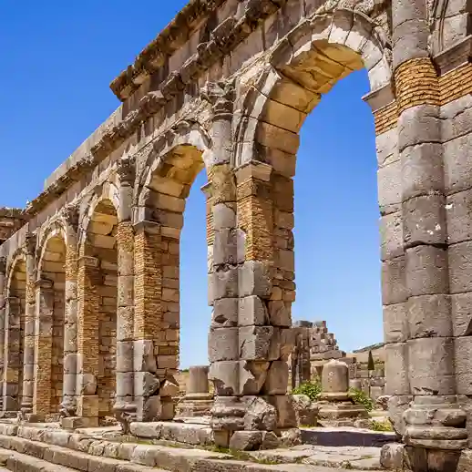 Archaeological remains and ancient columns at Volubilis Roman ruins Morocco. Visit Morocco Tours. Visit Morocco Tours