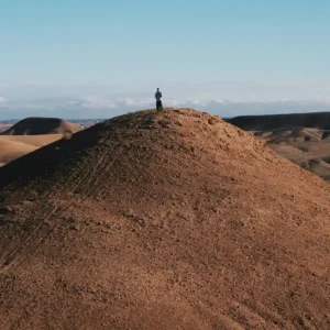 Visit Morocco Tours - Panoramic view of Agafay stone desert with Atlas Mountains in background. Visit Morocco Tours