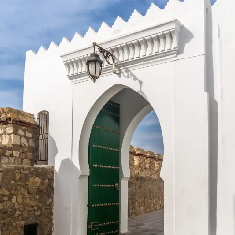 A beautiful blue and white gateway entrance to the ancient medina of Asilah on Morocco's Atlantic coast. Visit Morocco Tours