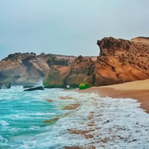 Aerial view of the serene Oualidia Lagoon on Morocco's Atlantic coast, known for oyster farming and birdwatching. Visit Morocco Tours