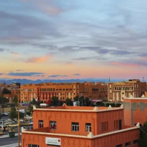 Visit Morocco Tours - Panoramic view of Ouarzazate city with the Atlas Mountains in the background. Visit Morocco Tours