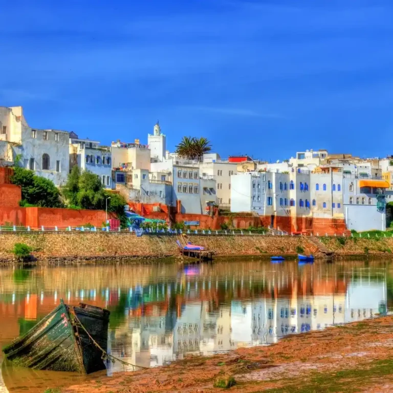 The Oum er-Rbia River flows past traditional Moroccan houses in a scenic landscape with Visit Morocco Tours. Visit Morocco Tours